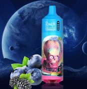 RandM Tornado 9000 blue disposable vape with vibrant alien artwork, surrounded by fresh blueberries and blackberries