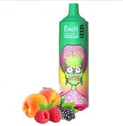 RandM Tornado vape with alien afro design, surrounded by peaches, raspberries, and blackberries on a white background