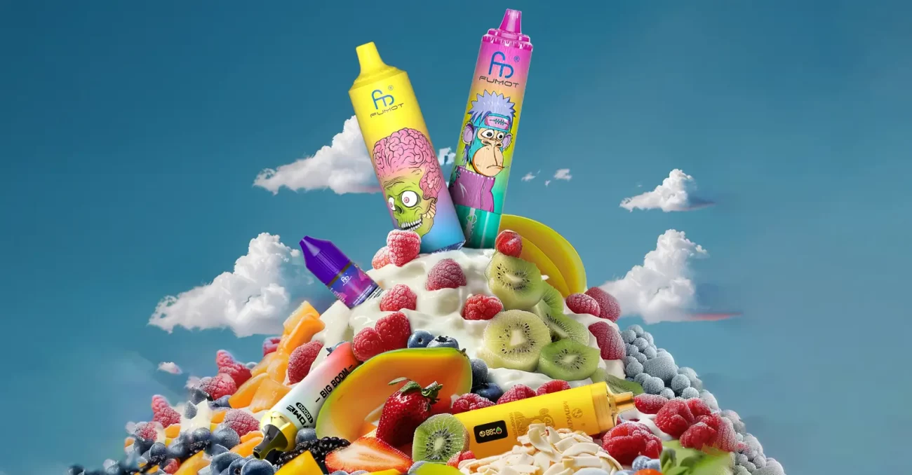 Fumot disposable vapes with cartoon designs displayed atop a yogurt and fruit mountain against a blue sky with clouds