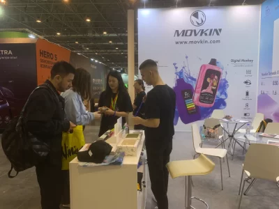 Attendees interact with MOVKIN representatives at Vape Club Show 2025 booth displaying Digital Monkey vape products